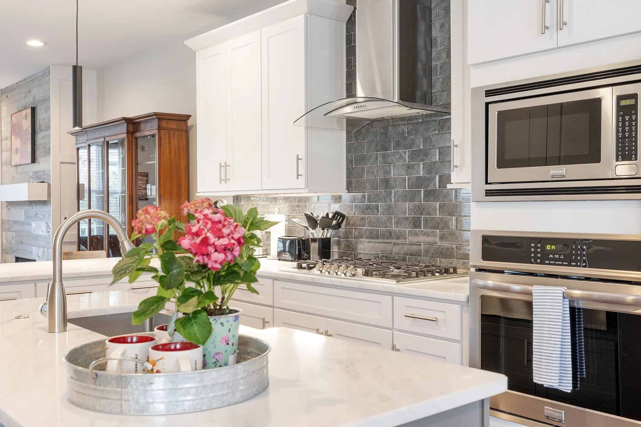 Kitchen remodel by Worsham LLC — white shaker cabinets, quartz island with undermount sink, gray subway tile backsplash, stainless appliances, Welcome Inn Nashville